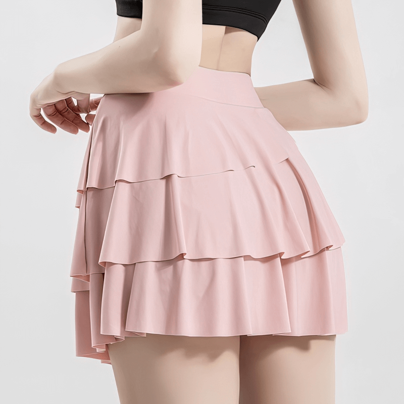 Stylish pink ruched skirt-shorts for women, perfect for sports and fitness, with elastic waistband for a comfortable fit.